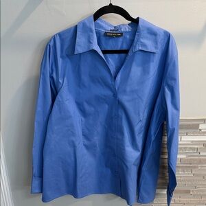 Designer blouse with v-neck and cuffed long sleeves.